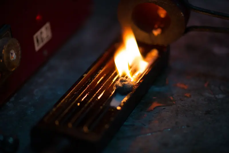 Detailed close-up of a burning candle wick melting wax indoors, creating warm illumination